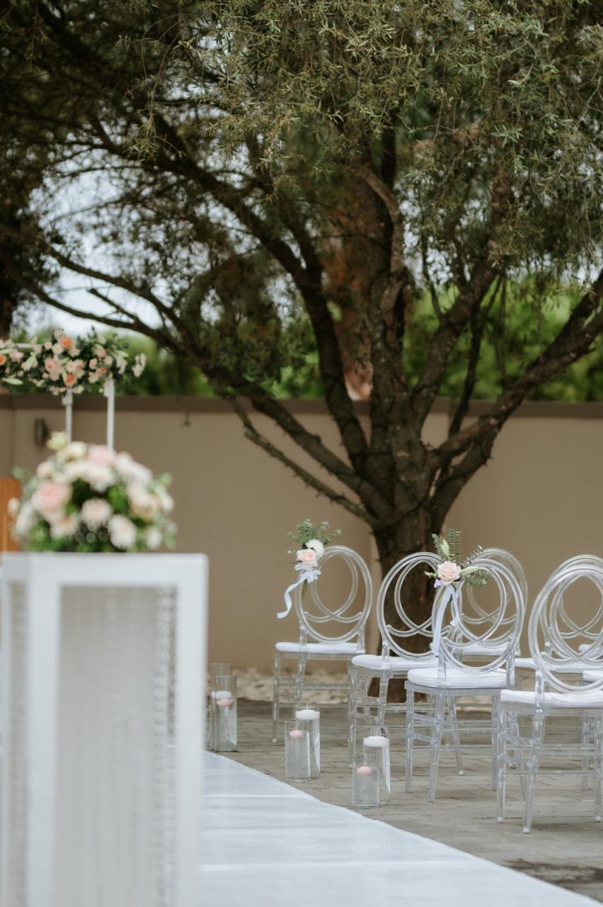 Garden ceremony seating dressed with roses