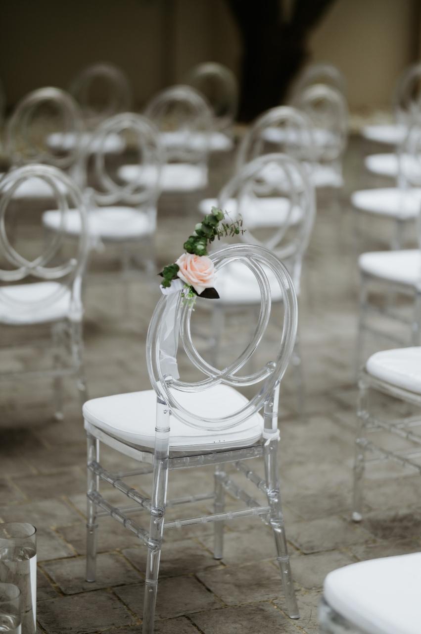 Clear phoenix chair styled with a blush rose